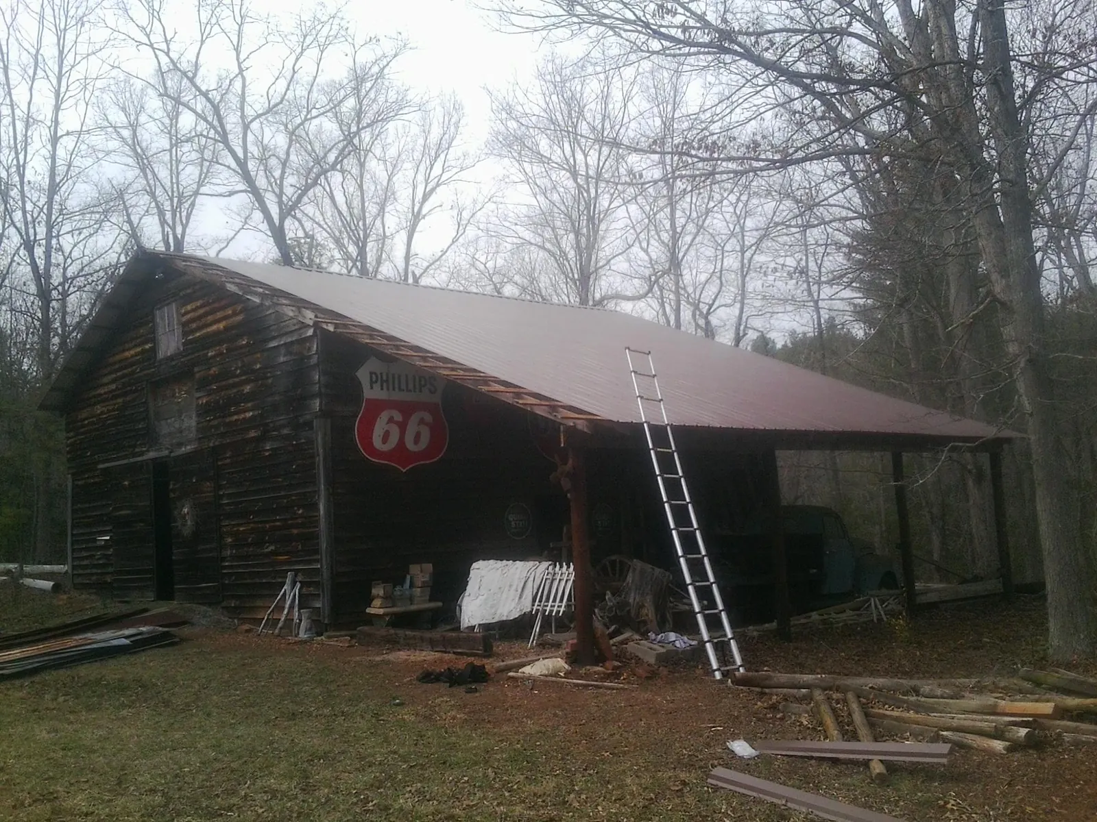 New metal roof on an open sided timber barn with a vintage sign in Shickshinny